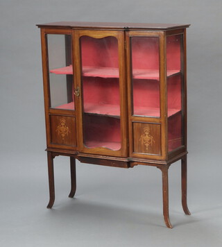 An Edwardian inlaid mahogany breakfront display cabinet, the shelved interior enclosed by glazed panelled doors, raised on outswept supports 123cm h x 93cm w x 37cm d 