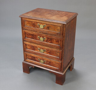 An oak chest of 4 long drawers raised on bracket feet with brass swan neck drop handles 77cm h x 56cm w x 40cm d 