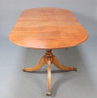 A Georgian style mahogany D end extending dining table with 2 extra leaves, raised on a pillar and tripod base, brass caps and casters 75cm h x 107cm w  x 167cm l x 252cm l with the leaves 