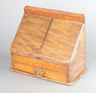 An oak stationery box of wedge form, having a stepped interior and drawer to base 22cm h x 29cm w x 14cm d 