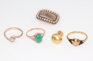 Three yellow metal rings, gross 7.2 grams, a yellow metal mushroom charm and a 19th Century gilt memoriam pearl set brooch  