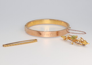 A 9ct yellow gold bangle 8.6 grams, ditto plain bar brooch 1.3 grams together with an Edwardian 15ct peridot and seed pearl brooch 3.5 grams 