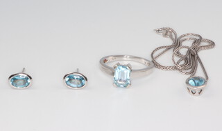 A 9ct white gold suite of jewellery comprising a topaz ring size M, a ditto necklace and pendant and a pair of ear studs, gross weight 7.4 grams 