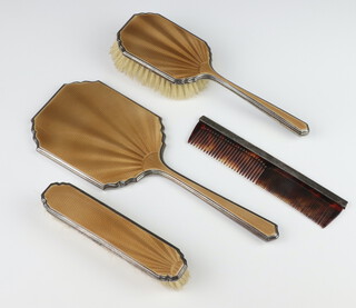 A silver and guilloche 3 part dressing table set comprising hand mirror, hair brush and clothes brush Birmingham 1947 and a mounted comb 