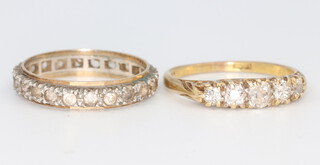 A yellow metal stamped 18ct 5 stone diamond ring, 3.1 grams, size M together with a gem set eternity ring size M, 2.2 grams