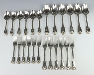 A matched canteen of George IV and Victorian silver fiddle, shell and thread pattern cutlery comprising 6 table spoons, 6 dessert spoons, 6 dinner forks, 6 dessert forks, mixed dates and makers, all with an engraved crest, 2204 grams 
