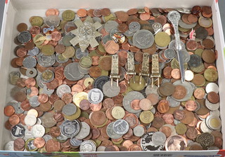A Blackwatch cap badge and a collection of world coins