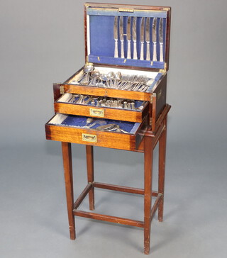 A part canteen of silver plated flatware contained in an oak canteen box, raised on a stand