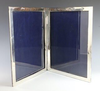 A double white metal photograph frame with armorial decoration 65cm x 42cm, dated to the top 1912 