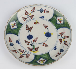 An 18th Century Continental Delft plate decorated with stylised flowers and insects 22cm 