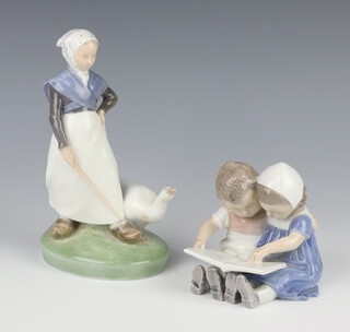 A Royal Copenhagen figure of a goose girl 528 19cm and a ditto of a seated girl and boy reading a book 1567 10cm