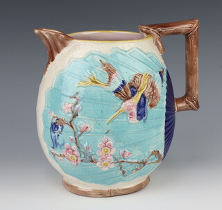 A Victorian Majolica style jug with rustic handle decorated with birds amongst peony 22cm 