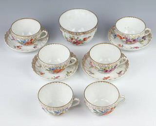 A German porcelain part tea set comprising 6 tea cups, 4 saucers and a sugar bowl decorated with flowers 