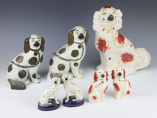 A Victorian Staffordshire Spaniel with ochre decoration 34cm (a/f), a Victorian ditto with black decoration (firing crack) 24cm with separate paw, a ditto 22cm with separate paw, a pair of later ochre ditto 13cm and a pair of dalmatians on raised bases 13cm  