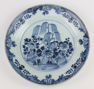 A Japanese blue and white glazed plate with tree decoration to the centre 23cm 