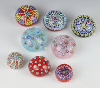Eight Peter McDougall paperweights including two 2 1/2"Â spaced complex Millefiori weights, one on a pink lace ground and one light blue lace ground, circa 2000, a small crown paperweight with complex cane on topÃƒ?Ã‚Â  with 20 twist canes with alternating colors, 10 white twist canes and 10 multi-colored twists made from yellow, white and green stringers set on a red ground, a 2"Â spaced complex Millefiori weight set on an opaque red ground, a 1 1/2"Â ribbed weight set blue & white canes and twists on an opaque red ground and three further 2 1/2"Â weights 