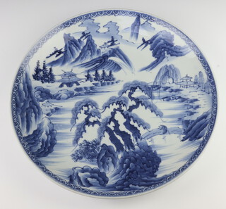 A Japanese Imari charger decorated landscapes and buildings 41cm 