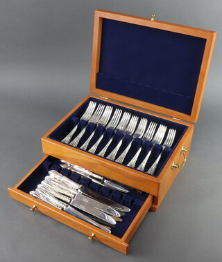 A modern canteen of silver plated lily pattern cutlery for 12 comprising 12 dessert forks, 12 dinner forks, 12 dinner knives, 16 dessert knives