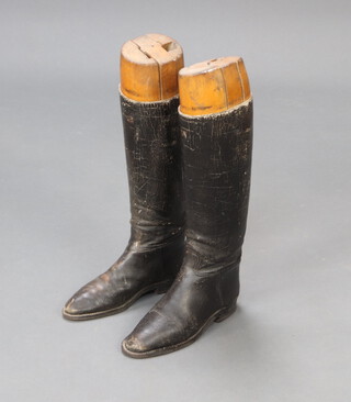 A pair of black leather riding boots complete with beech trees 