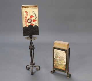 A 1920's wrought iron oversized matchbox holder with box of matches, the base incorporating an ashtray, raised on scrolled supports 87cm h x 20cm x 13cm together with 1 other pressed metal oversized matchbox holder 40cm x 20cm x 6cm, the side decorated a hunting print  
