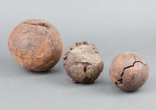 A 12cm canon ball (cracked) and 2 other canon balls (both corroded) 7cm and 8cm 