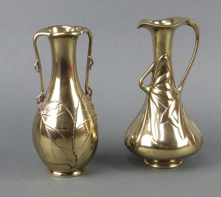 An Eastern polished bronze twin handled jug with leaf decoration 22cm x 5cm together with a similar jug 23cm x 5cm 
