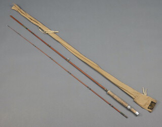 A Ferrio 85 2 piece, 7' spinning fishing rod contained in a brown cloth bag 


