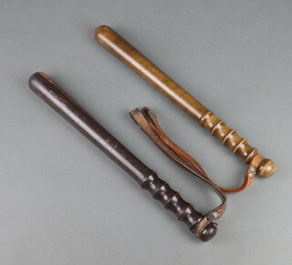 A turned lignum vitae Police truncheon complete with a leather thong and 1 other (2) 