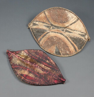A Massai hide leaf shaped shield 70cm x 51, 1 other 68cm x 36cm 
