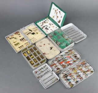 Four Wheatley fly fishing boxes and contents together with two plastic fly boxes containing salmon and trout flies  