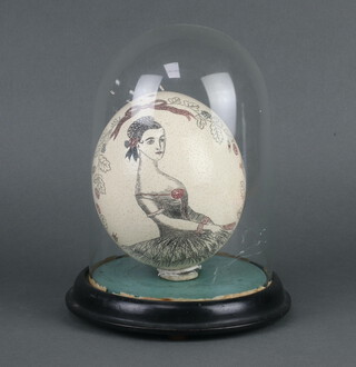 A carved ostrich egg decorated a figure of a lady and a 3 masted sailing ship 16cm complete with glass dome 