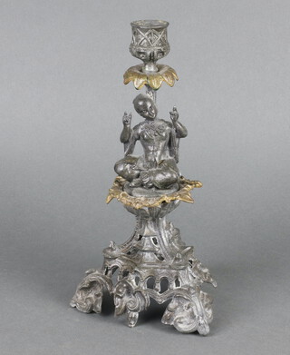 A 19th Century cast metal candlestick in the form of a seated figure, raised on a pierced base 26cm x 13cm 