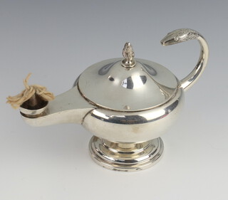 A silver cigar lighter in the form of a Roman oil lamp on a circular base, London 1915 by the Goldsmiths and Silversmiths Company, 220 grams 