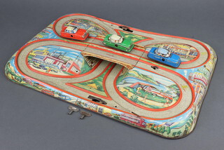 A Jennings tinplate clockwork motorway racing game 49cm x 33cm complete with 3 cars  