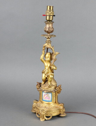 A 19th Century gilt metal candlestick with later sconce and serpent porcelain panel, converted to a table lamp 39cm 