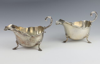 A pair of silver sauce boats with bracketed border Birmingham 1926 and 1927, 448 grams 