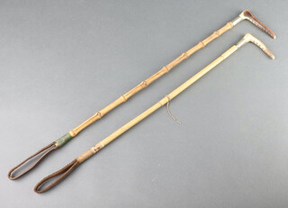 Two bamboo riding crops with stag horn handles