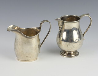 A Georgian style silver cream jug Chester 1915 together with a Georgian style silver cream jug with sparrow beak London 1916, 148 grams 