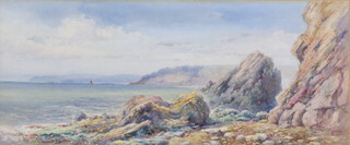 Watercolour, rocky beach scene with fishing boats, indistinctly signed and dated to bottom left hand corner, 20cm x 48cm 