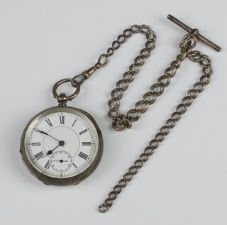An open faced half hunter pocket watch with enamelled dial and Roman numerals, subsidiary second hand, contained in a white metal case hung on a silver Albert chain 