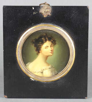 An 18th/19th Century circular portrait miniature on copper, study of a lady, 8cm, contained in an ebonised and gilt mounted frame 