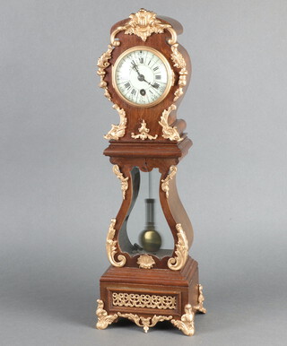 A Continental mantel timepiece, the 8cm enamelled dial with Roman numerals, contained in a walnut and gilt mounted case, having a gridiron pendulum 48cm h x 10cm w x 18cm d, complete with key 