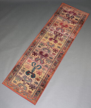 A rust ground Persian style machine made runner with stylised medallion to the centre 225cm x 75cm 
