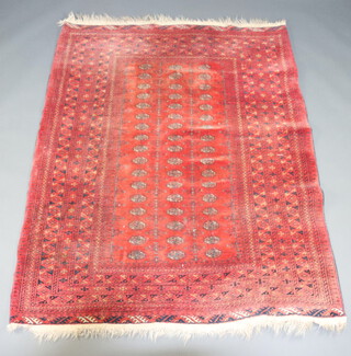 A red and blue ground Afghan rug with 51 octagons to the centre 206cm x 159cm 