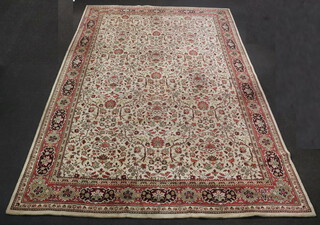 A terracotta and cream ground machine made Persian style carpet 500cm x 337cm 