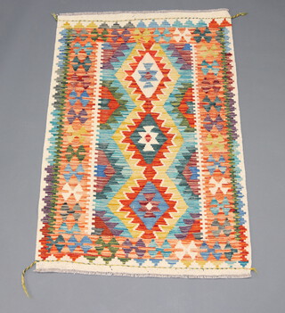 A yellow, turquoise and green ground Chobi Kilim with 3 diamonds to the centre 125cm x 85cm 