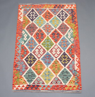 A green, white and orange ground Chobi Kilim rug with all over diamond design 150cm x 100cm 