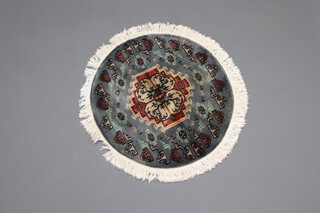 A blue and grey ground Moji Jaldar circular rug with medallions to the centre surrounded by hooked medallions 63cm diam.