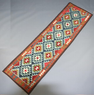 A green, white and tan ground Maimana Kilim runner with all over geometric designs 293cm x 85cm 
