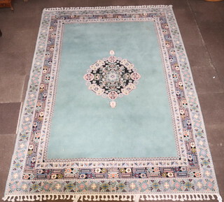 A Turkey green ground and floral patterned carpet with central medallion 343cm x 252cm 